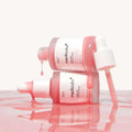 Two Medicube Pink Peptide Serum bottles with serum drip effect