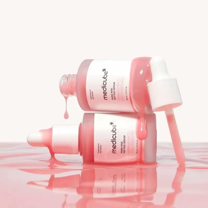 Two Medicube Pink Peptide Serum bottles with serum drip effect