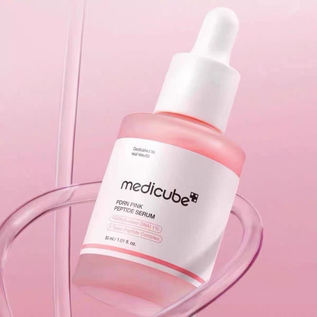 Close-up of Medicube Pink Peptide Serum texture and dropper
