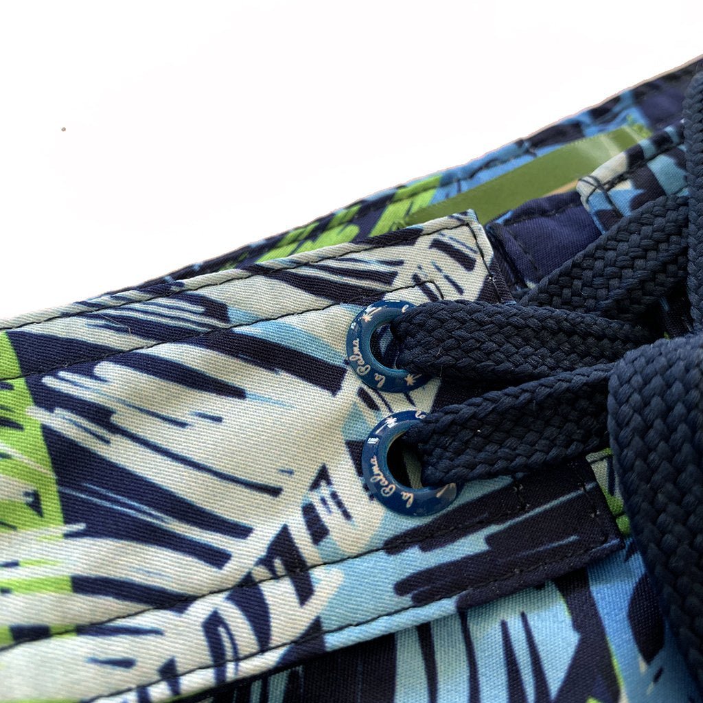 Close-up detail of men’s botanical print boardshorts with adjustable drawstring waistband and durable fabric