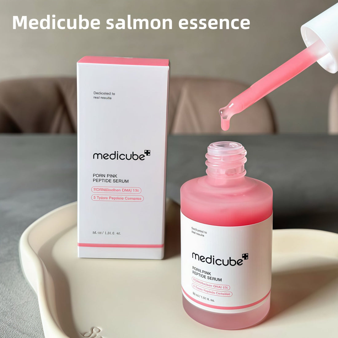 Medicube Pink Peptide Serum in dropper bottle on white background